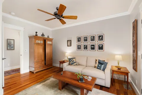 a living room with furniture and a wooden floor