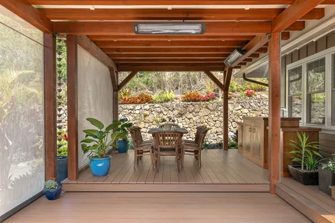 a view of a patio with table and chairs and potted plants