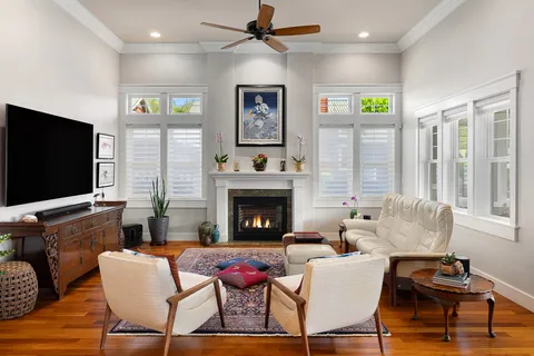 a living room with furniture a flat screen tv and a fireplace