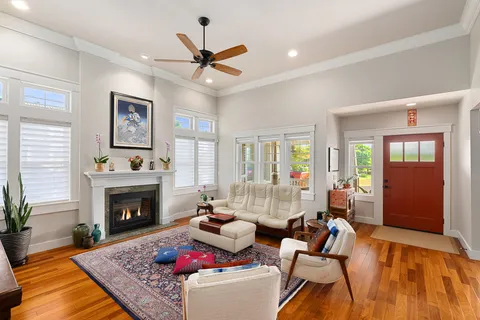 a living room with furniture fireplace and window