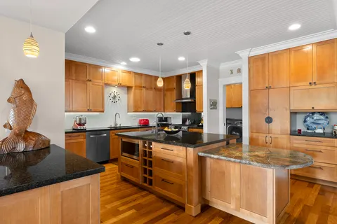 a kitchen with stainless steel appliances granite countertop sink stove and cabinets