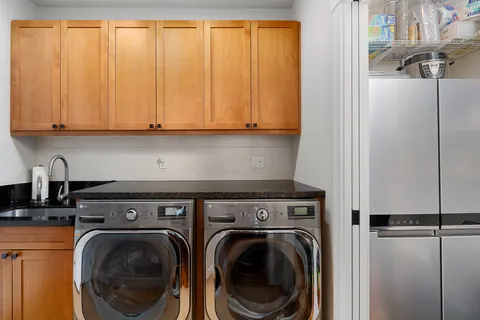 a view of a storage and utility room with washer and dryer