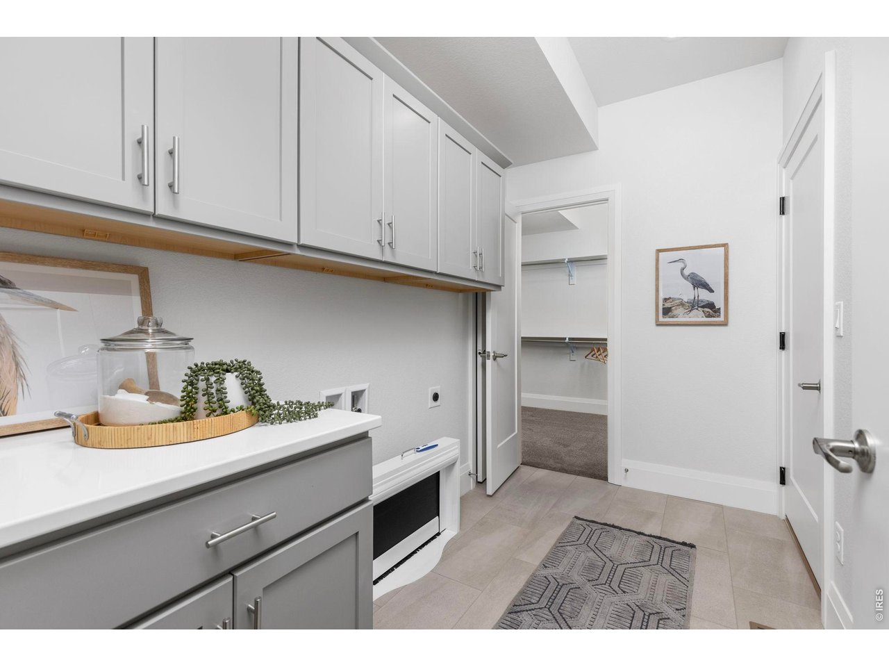 5700 West 2nd Street Road Greeley, CO 80634 - Photo 23 of 40 A convenient "drop-zone" in the mudroom/laundry room right off the garage, with plenty of storage & a utility closet, plus access to the primary bedroom clothes closet!
