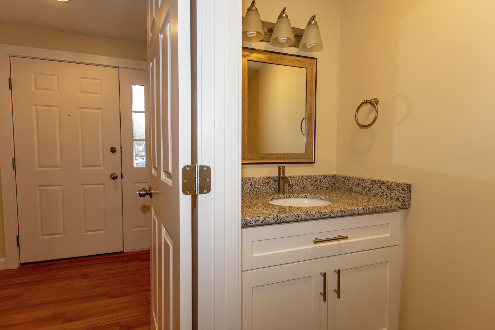 52 Shellback Way, Unit H Mashpee, MA 02649 - Photo 4 of 20 a bathroom with a granite countertop sink and a mirror