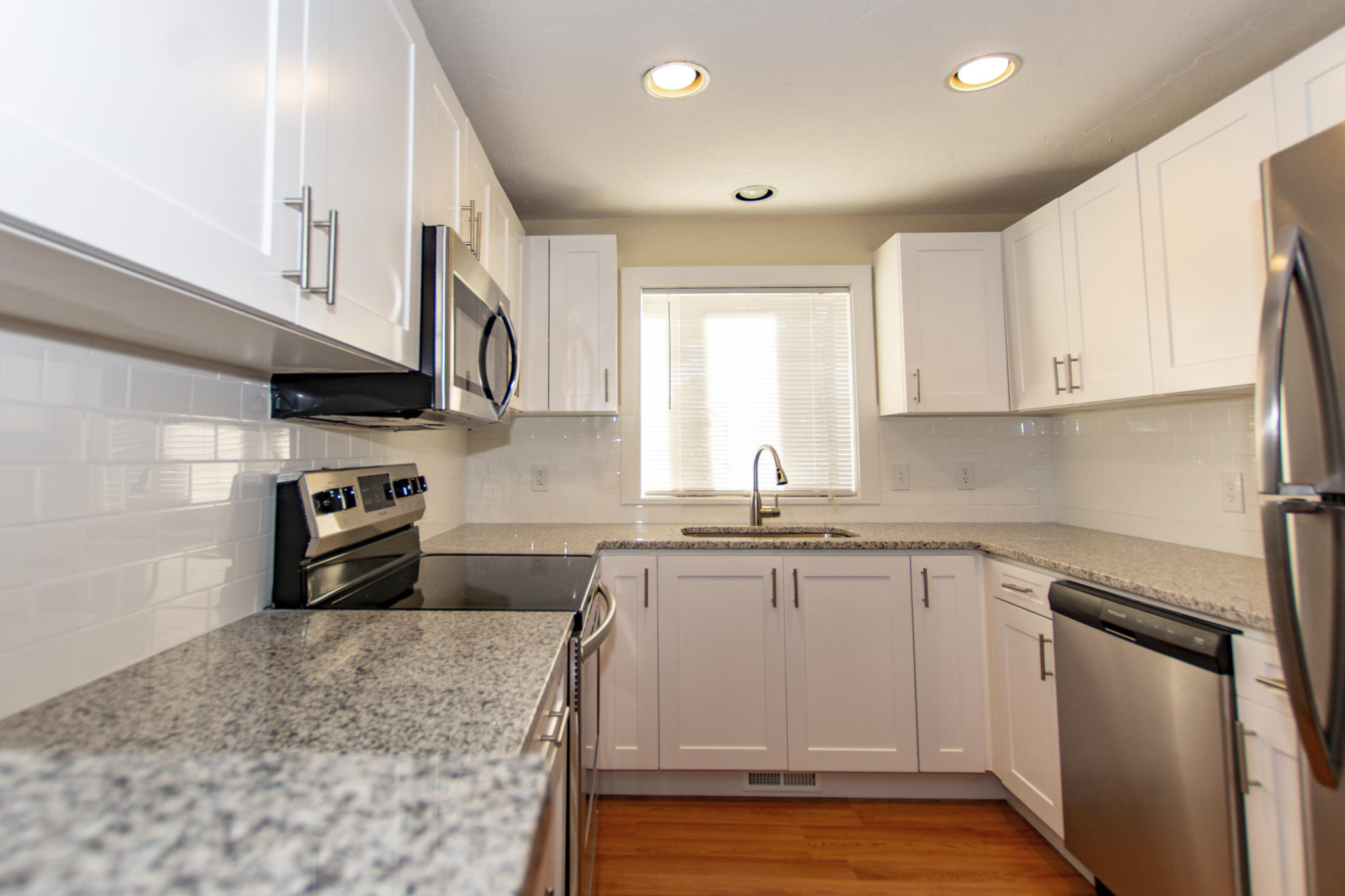 52 Shellback Way, Unit H Mashpee, MA 02649 - Photo 6 of 20 a kitchen with stainless steel appliances granite countertop a sink stove and cabinets