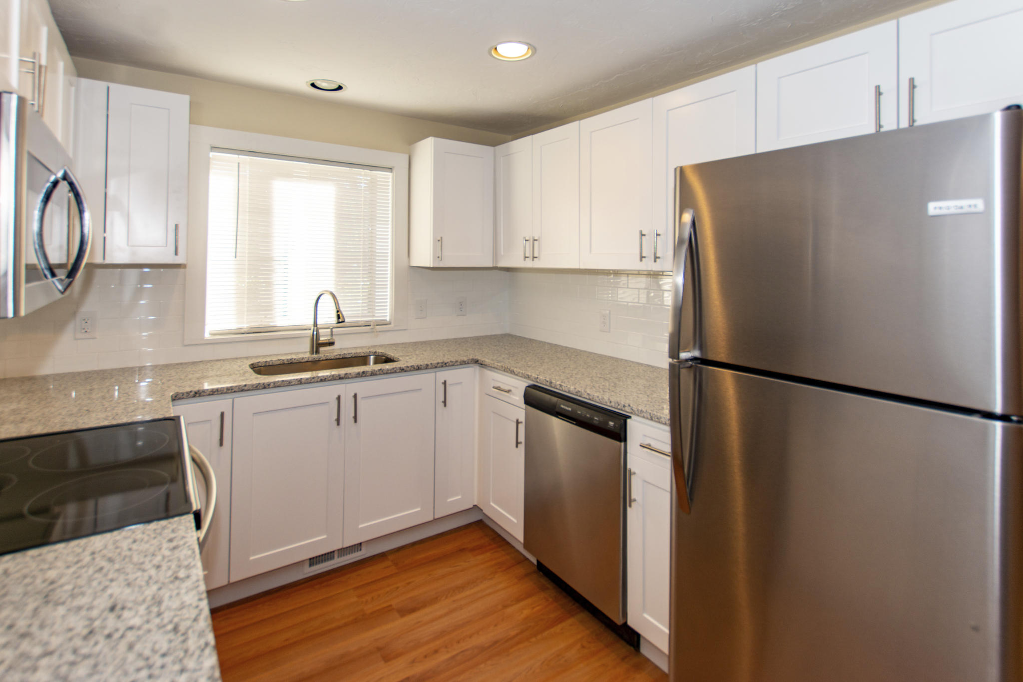 52 Shellback Way, Unit H Mashpee, MA 02649 - Photo 7 of 20 a kitchen with a refrigerator sink and cabinets