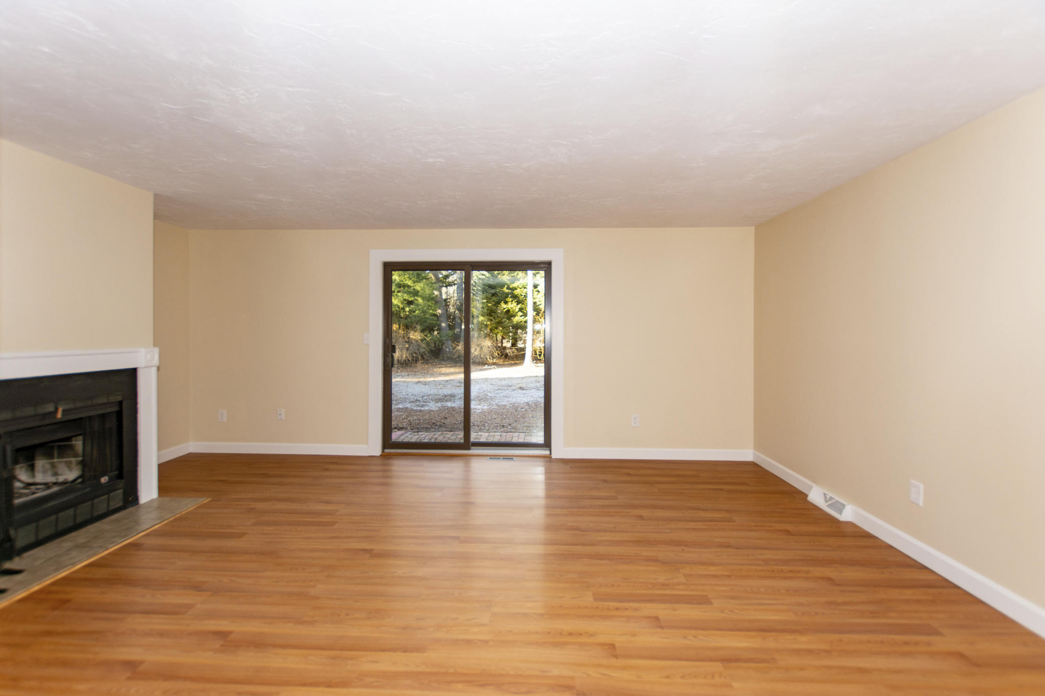 52 Shellback Way, Unit H Mashpee, MA 02649 - Photo 10 of 20 a view of an empty room with a fireplace and a window