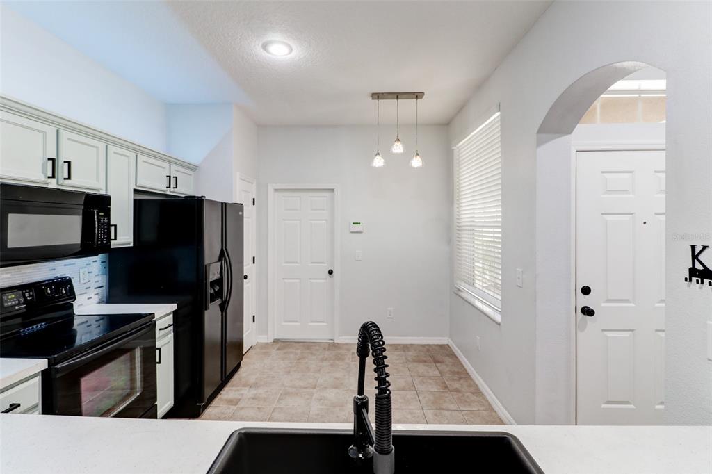 6243 Duck Key Court Tampa, FL 33625 - Photo 12 of 38 a kitchen with a refrigerator and a stove top oven