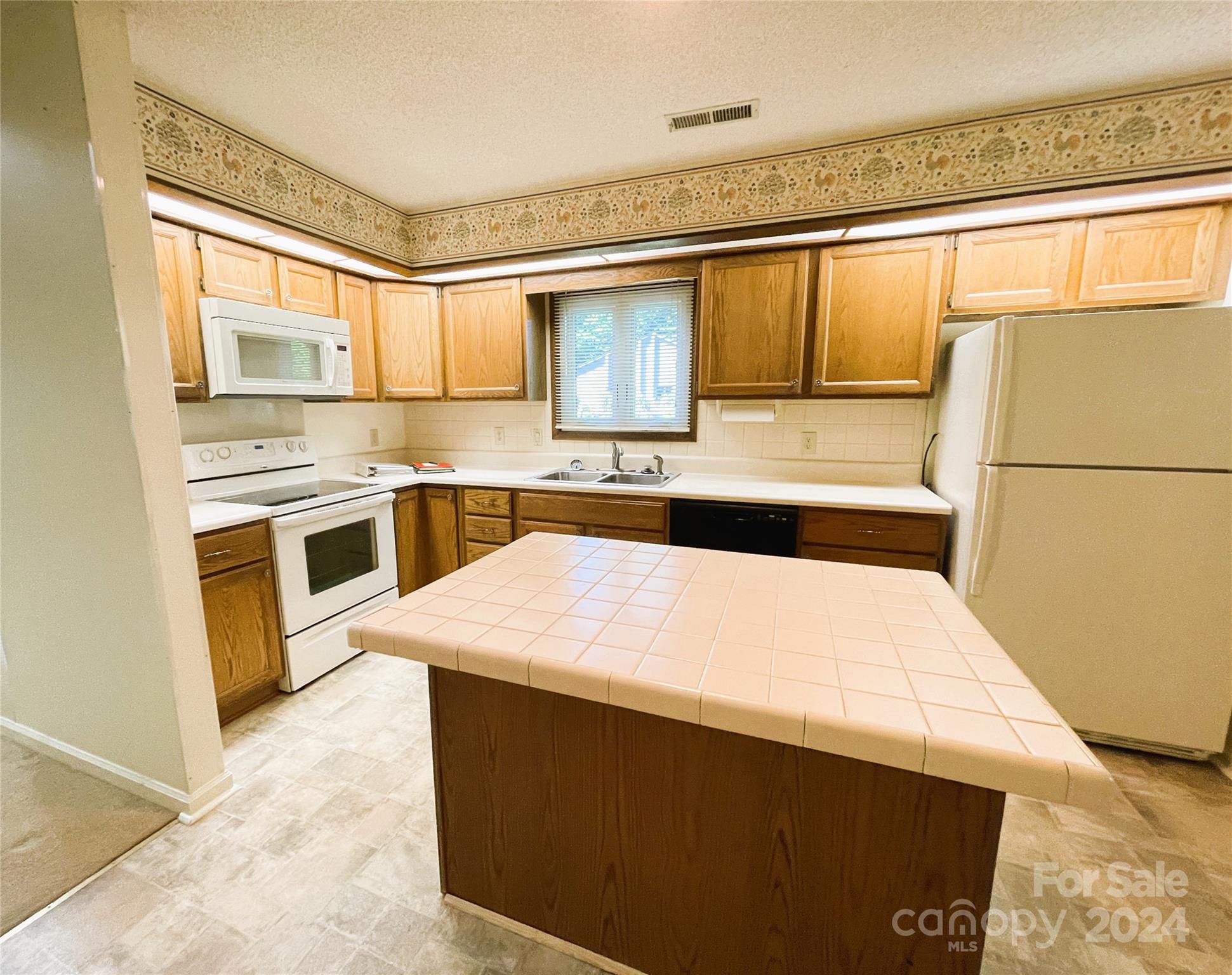 101 Independence Trail Morganton, NC 28655 - Photo 13 of 45 a kitchen with a sink a stove top oven and stainless steel appliances