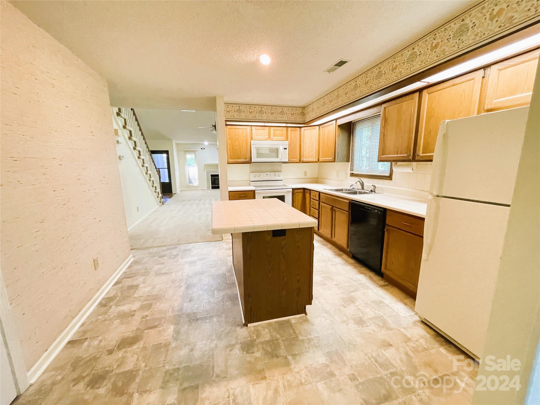 101 Independence Trail Morganton, NC 28655 - Photo 14 of 45 a kitchen with stainless steel appliances granite countertop a stove top oven a sink a counter top space and cabinets