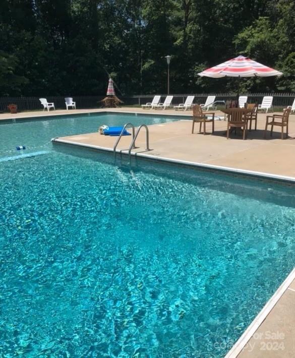 101 Independence Trail Morganton, NC 28655 - Photo 45 of 45 a view of swimming pool with a table and chairs under an umbrella
