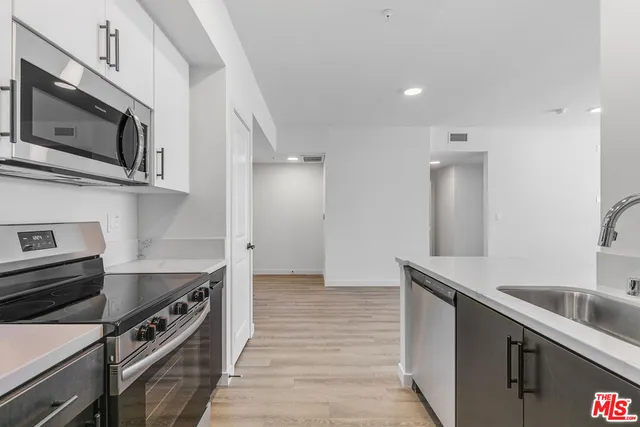 a kitchen with stainless steel appliances and a sink