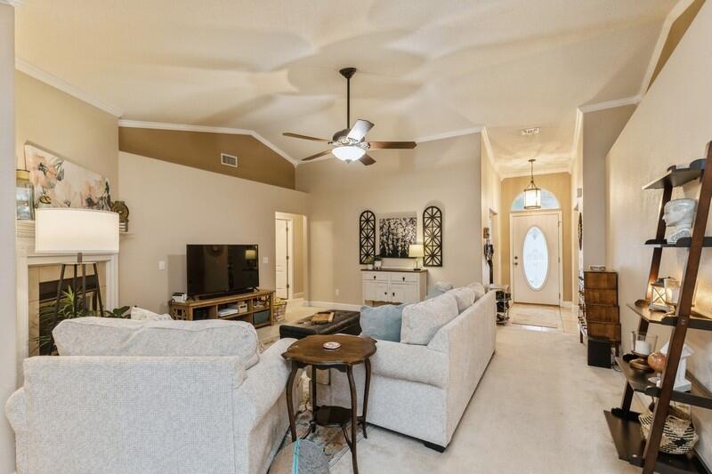 422 Swift Fox Run Crestview, FL 32536 - Photo 11 of 35 a living room with furniture a fireplace and a flat screen tv