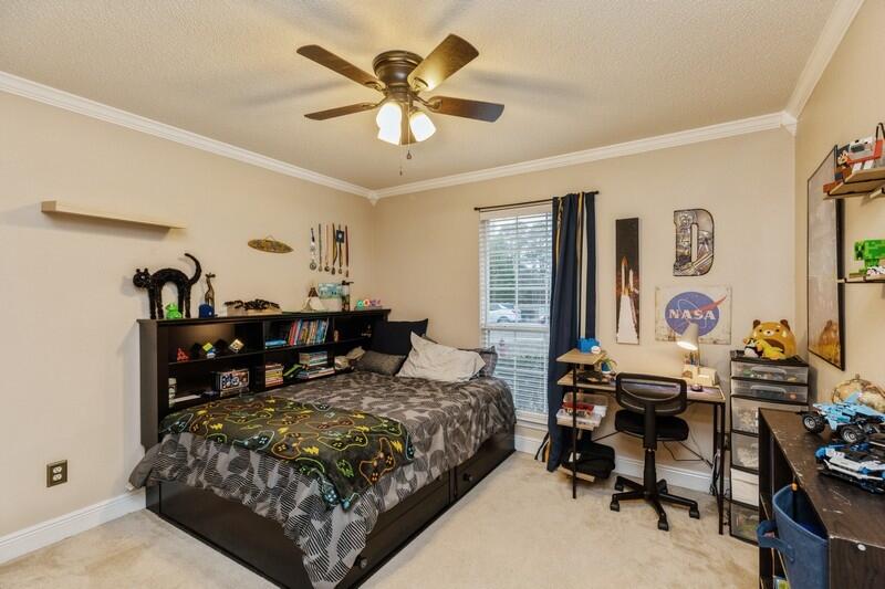 422 Swift Fox Run Crestview, FL 32536 - Photo 18 of 35 a bedroom with a bed and view of kitchen