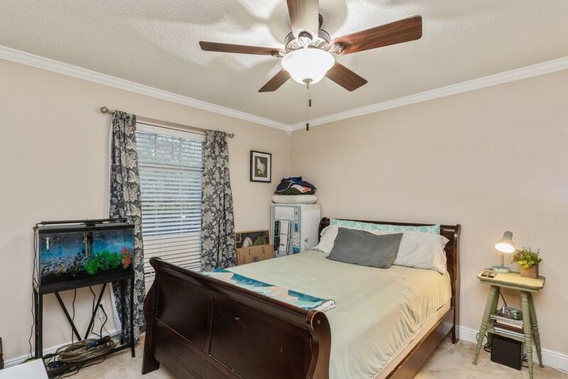 422 Swift Fox Run Crestview, FL 32536 - Photo 21 of 35 a bedroom with a bed and a potted plant