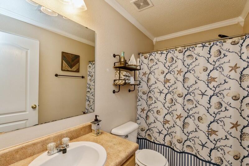 422 Swift Fox Run Crestview, FL 32536 - Photo 22 of 35 a bathroom with a shower curtain sink and a mirror