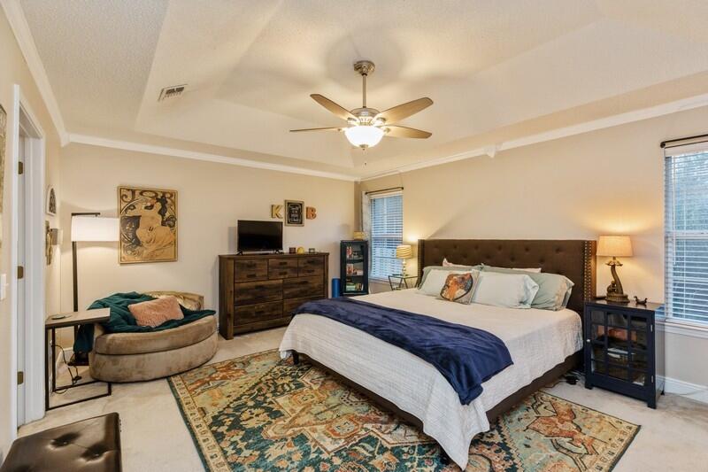 422 Swift Fox Run Crestview, FL 32536 - Photo 24 of 35 a bedroom with a bed a couch and a flat screen tv