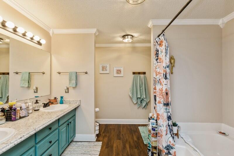422 Swift Fox Run Crestview, FL 32536 - Photo 27 of 35 a bathroom with a sink a mirror a vanity and a shower