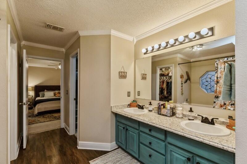422 Swift Fox Run Crestview, FL 32536 - Photo 30 of 35 a en suite bathroom with a double vanity sink and a mirror