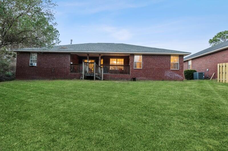 422 Swift Fox Run Crestview, FL 32536 - Photo 32 of 35 a view of a brick house with a yard