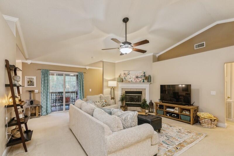 422 Swift Fox Run Crestview, FL 32536 - Photo 9 of 35 a living room with furniture a flat screen tv and a fireplace