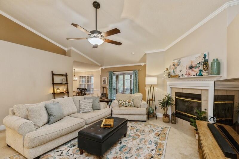 422 Swift Fox Run Crestview, FL 32536 - Photo 10 of 35 a living room with furniture a fireplace and a chandelier