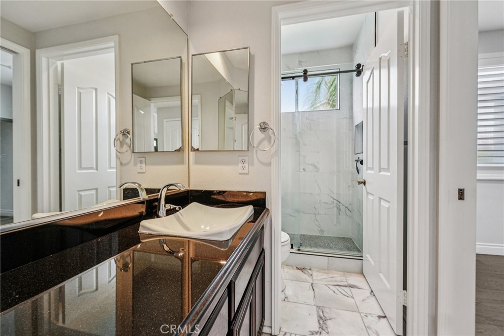 901 Clearwood Avenue Riverside, CA 92506 - Photo 12 of 36 a bathroom with a sink a toilet and shower