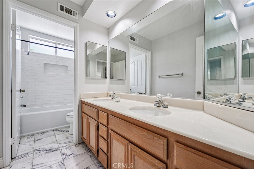 901 Clearwood Avenue Riverside, CA 92506 - Photo 19 of 36 a bathroom with a sink double vanity granite tub and shower