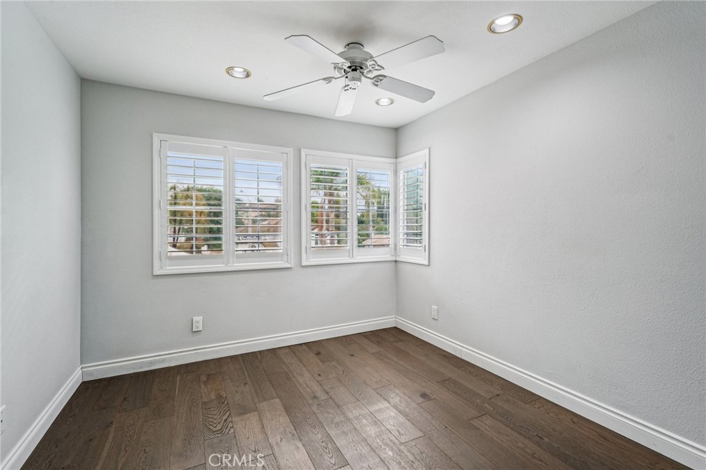 901 Clearwood Avenue Riverside, CA 92506 - Photo 20 of 36 an empty room with wooden floor and windows