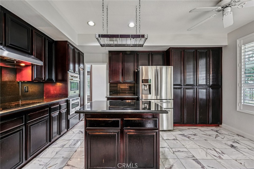 901 Clearwood Avenue Riverside, CA 92506 - Photo 2 of 36 a kitchen with stainless steel appliances kitchen island granite countertop a refrigerator and a stove top oven