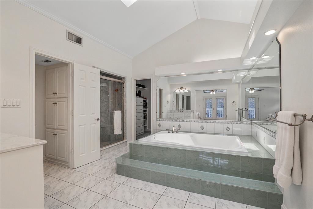 a spacious bathroom with a tub and shower