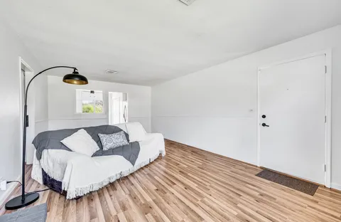 a bedroom with a bed and a large window