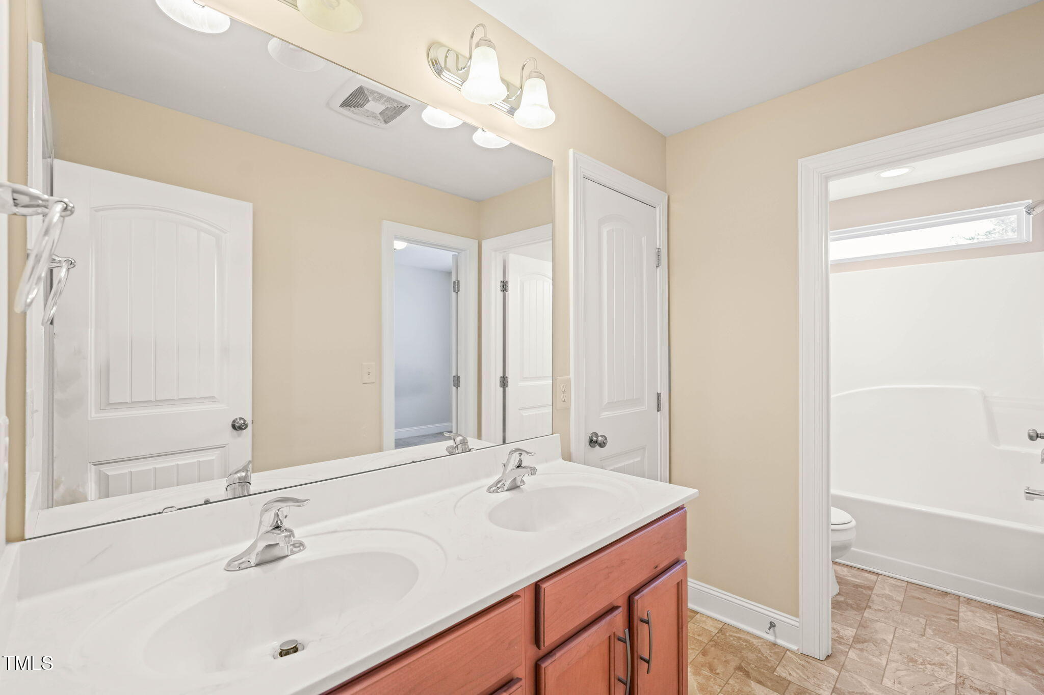 4508 Brintons Cottage Street Raleigh, NC 27616 - Photo 28 of 46 a bathroom with a sink double vanity and a mirror