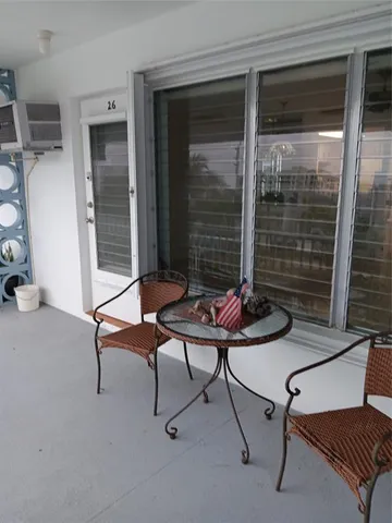 a view of a house with swimming pool and sitting area