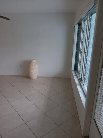 a view of an empty room and a window