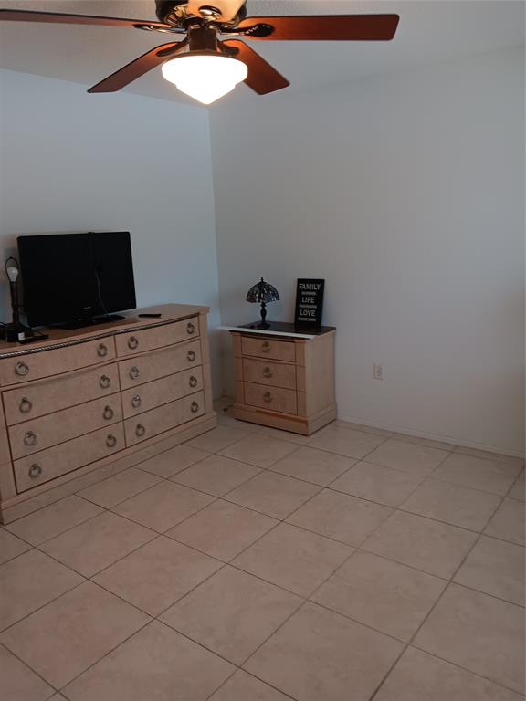 1110 North Riverside Drive, Unit 26 Pompano Beach, FL 33062 - Photo 7 of 17 a room with cabinets and flat screen tv