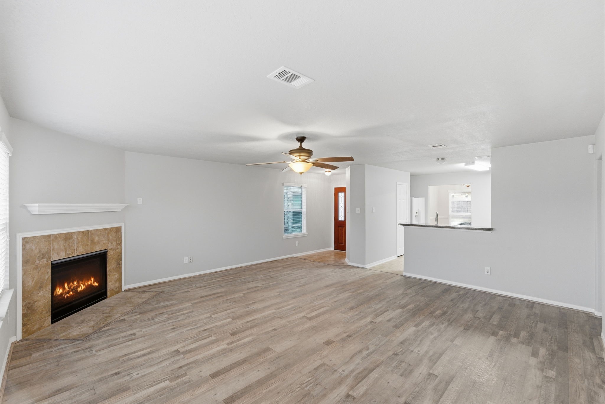 4910 Conifer Ridge Way Humble, TX 77346 - Photo 12 of 48 a view of an empty room with window and fireplace