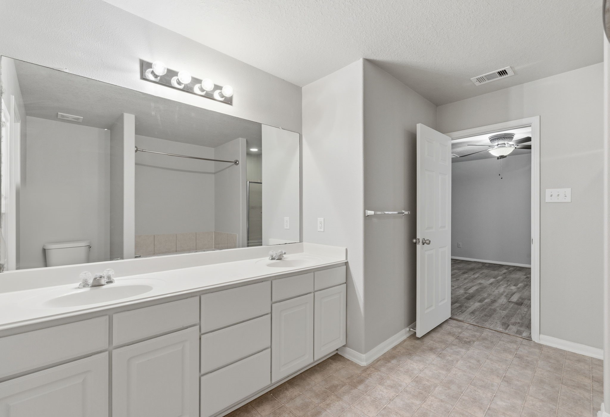 4910 Conifer Ridge Way Humble, TX 77346 - Photo 24 of 48 a bathroom with a double vanity sink a mirror and shower