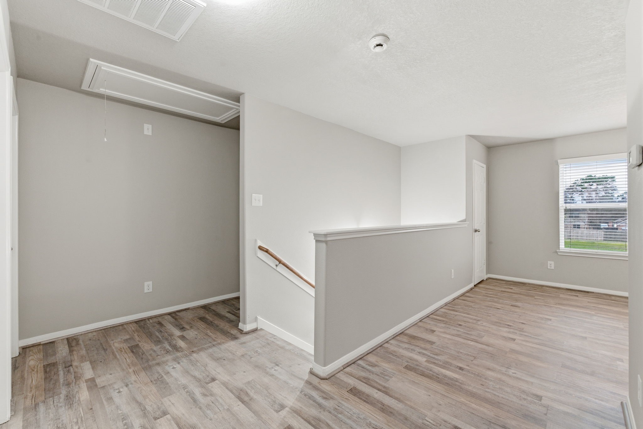 4910 Conifer Ridge Way Humble, TX 77346 - Photo 31 of 48 a view of an empty room with wooden floor and a window