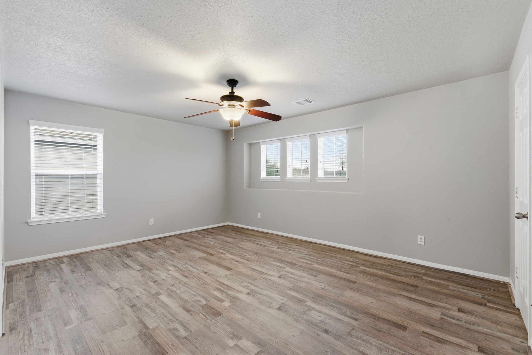 4910 Conifer Ridge Way Humble, TX 77346 - Photo 34 of 48 a view of an empty room with a window and wooden floor