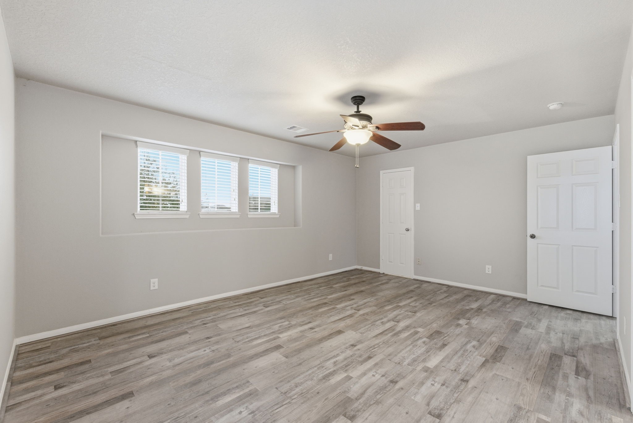 4910 Conifer Ridge Way Humble, TX 77346 - Photo 36 of 48 a view of an empty room with a chandelier fan