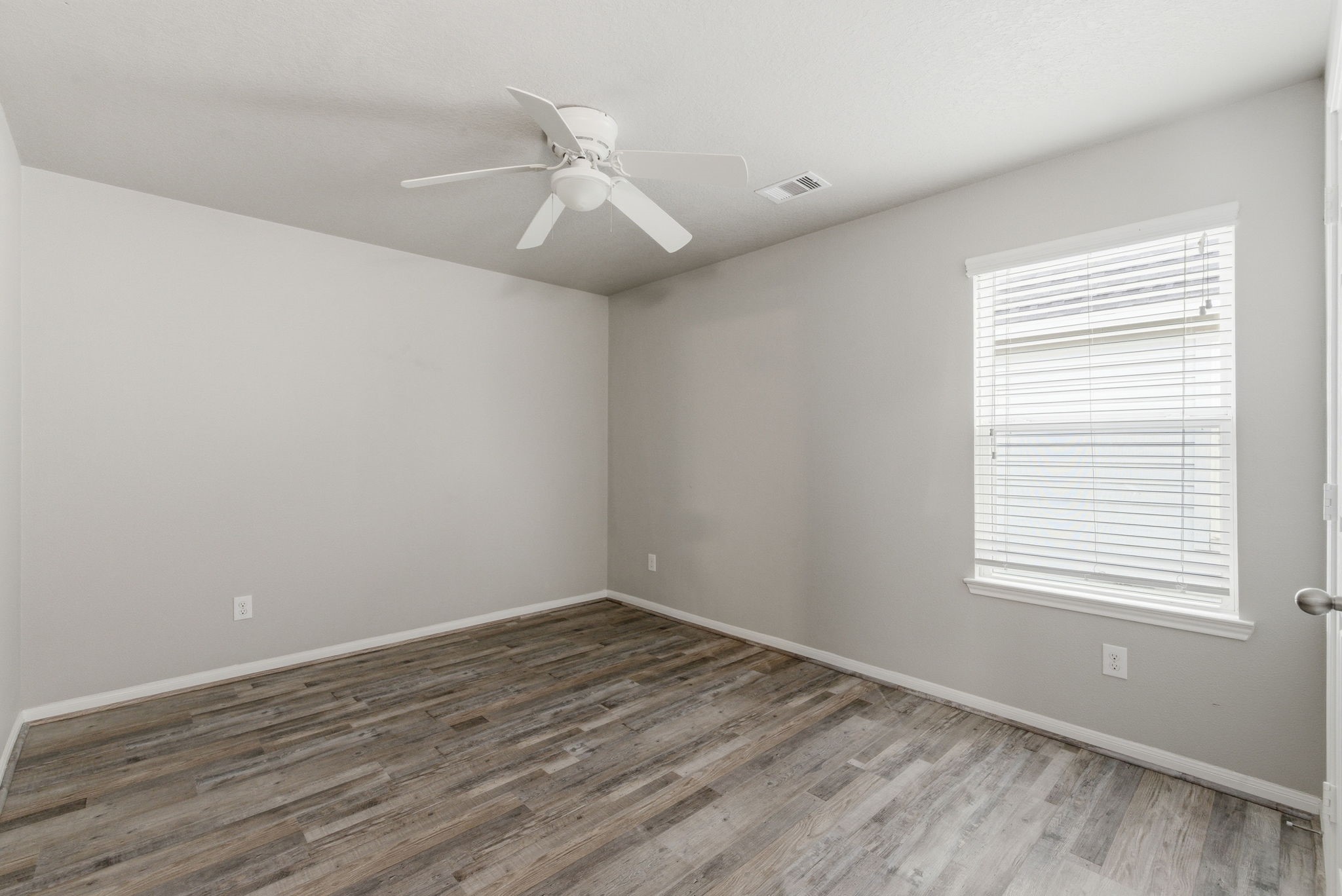 4910 Conifer Ridge Way Humble, TX 77346 - Photo 40 of 48 an empty room with wooden floor and windows