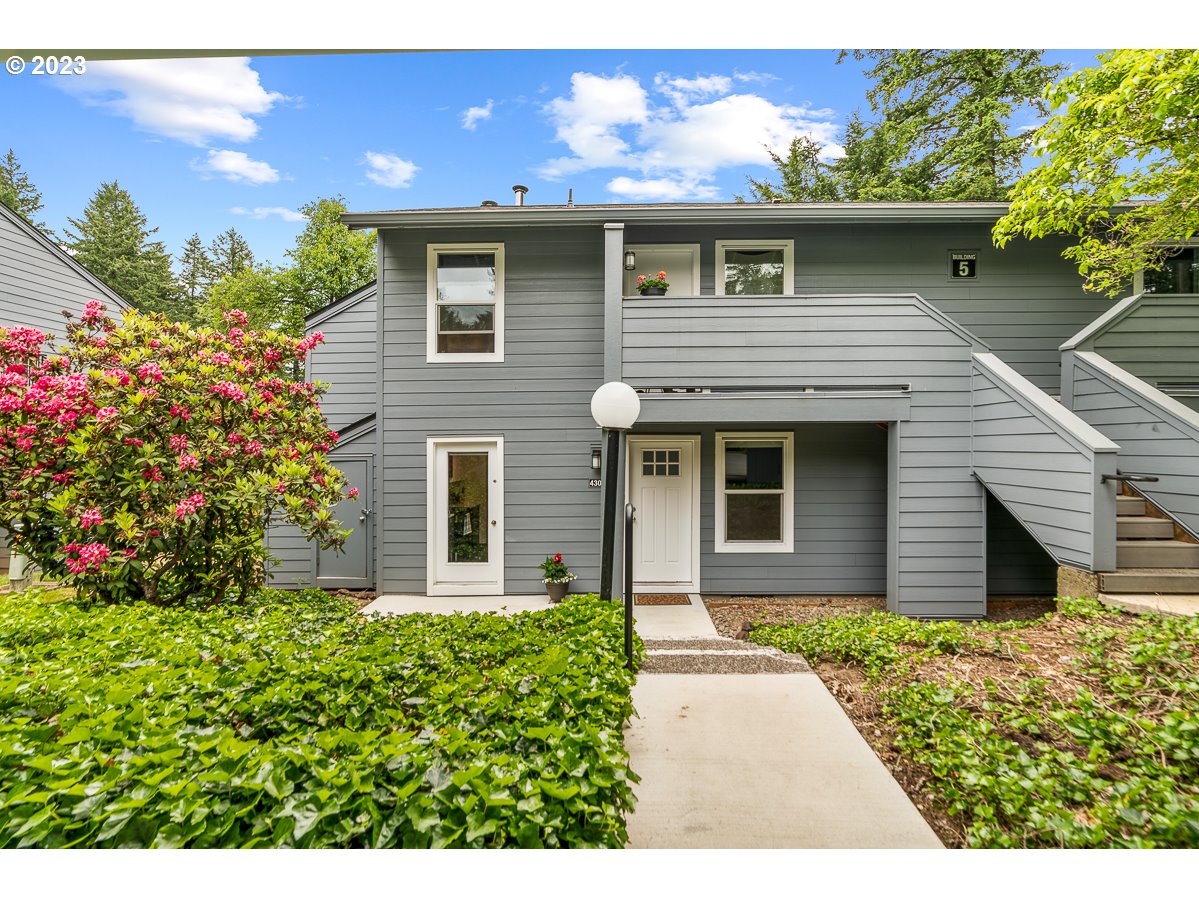 4308 Southwest Dickinson Street, Unit 15 Portland, OR 97219 - Photo 1 of 35 a front view of a house with garden