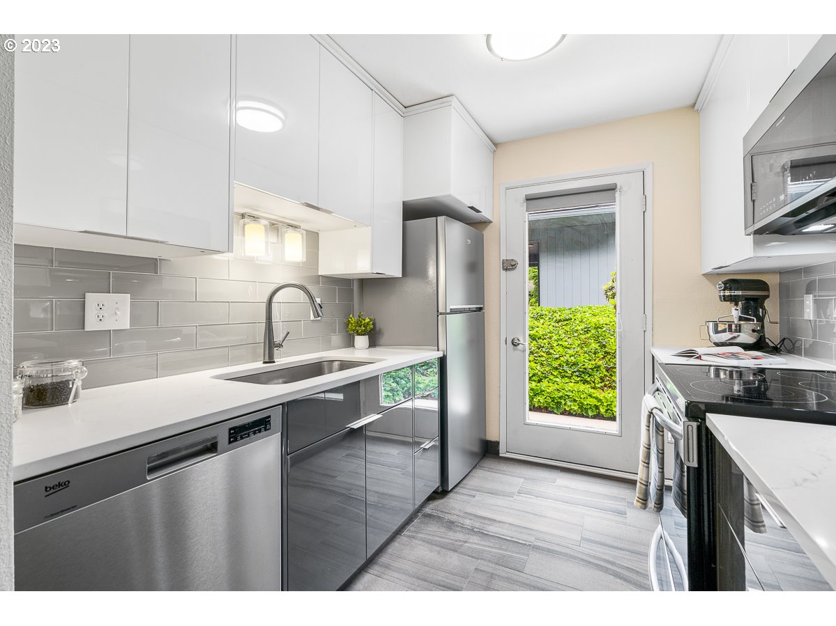 4308 Southwest Dickinson Street, Unit 15 Portland, OR 97219 - Photo 11 of 35 a kitchen with a sink appliances and a window