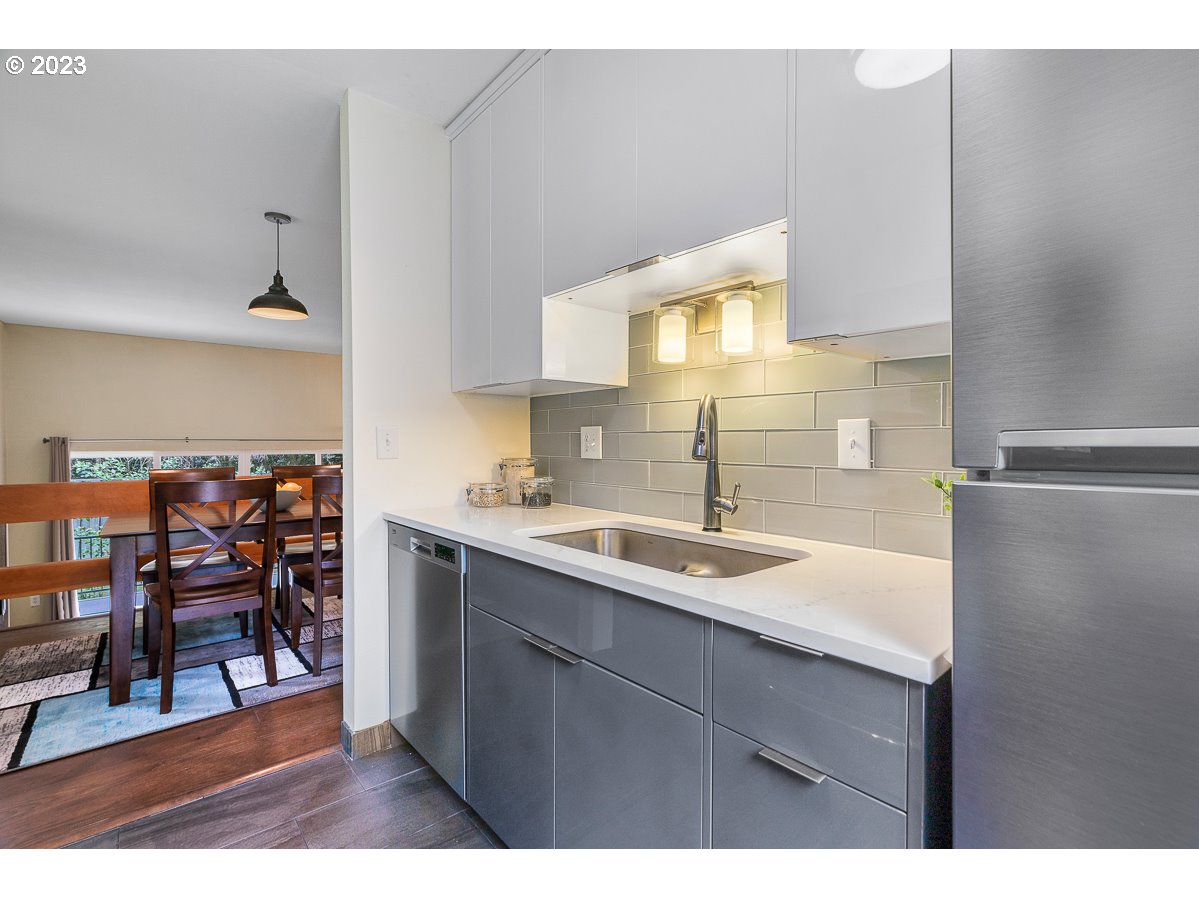 4308 Southwest Dickinson Street, Unit 15 Portland, OR 97219 - Photo 12 of 35 a kitchen with a sink cabinets and window