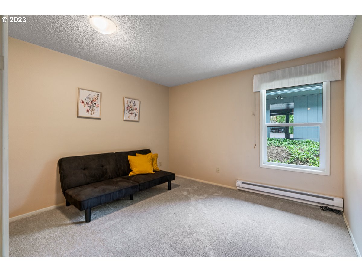 4308 Southwest Dickinson Street, Unit 15 Portland, OR 97219 - Photo 14 of 35 a living room with furniture and a window