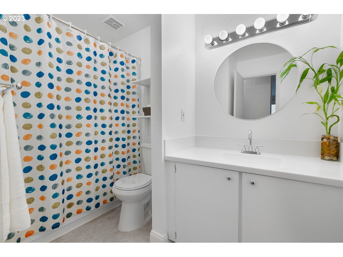 4308 Southwest Dickinson Street, Unit 15 Portland, OR 97219 - Photo 17 of 35 a bathroom with a sink and a mirror