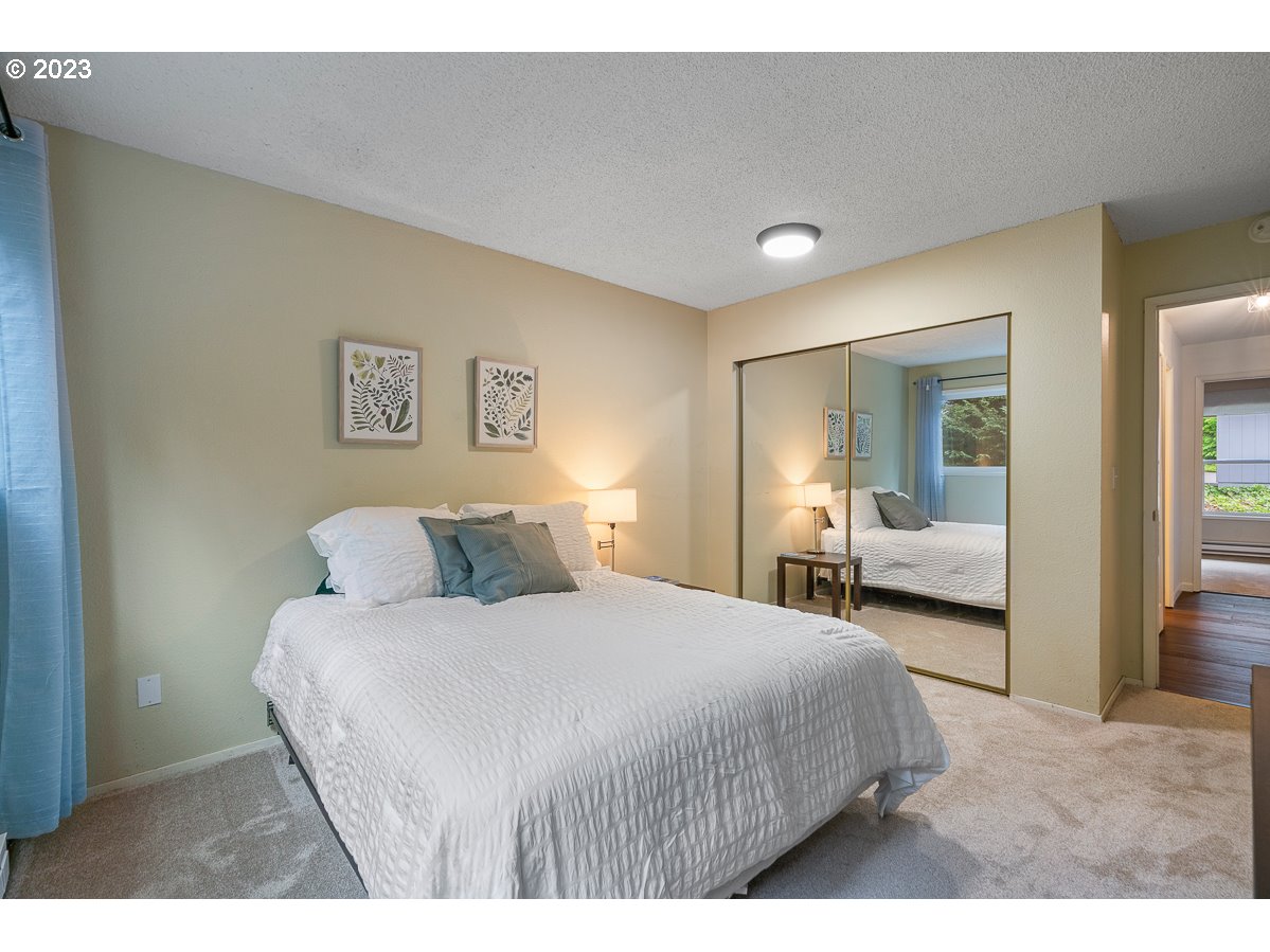 4308 Southwest Dickinson Street, Unit 15 Portland, OR 97219 - Photo 20 of 35 a bedroom with a bed and a couch