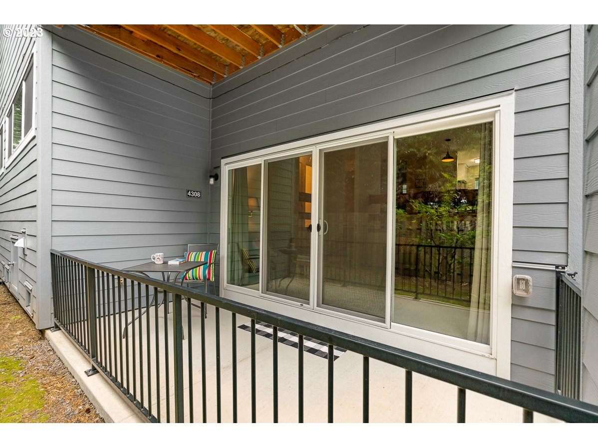 4308 Southwest Dickinson Street, Unit 15 Portland, OR 97219 - Photo 25 of 35 a view of a porch with a floor to ceiling window