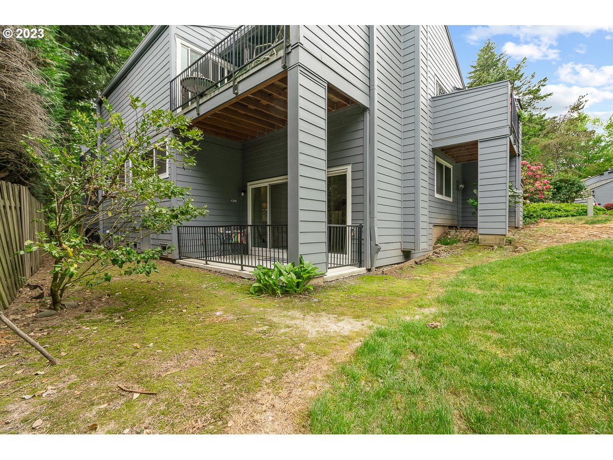 4308 Southwest Dickinson Street, Unit 15 Portland, OR 97219 - Photo 26 of 35 a view of a house with a backyard